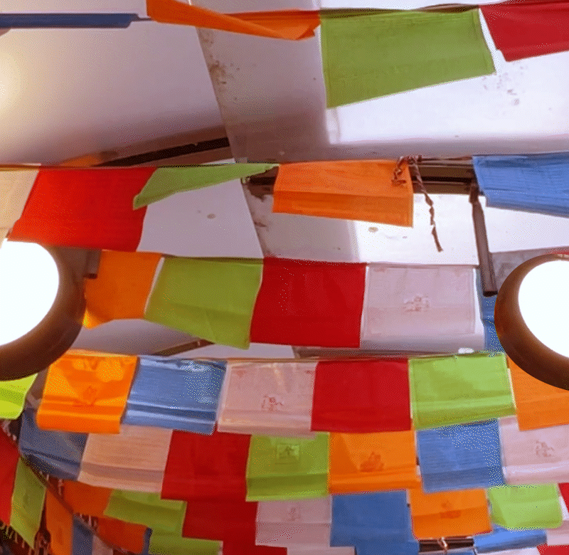 A looped gif of prayer flags fluttering in the wind